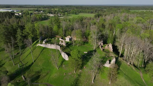 Moving away aerial of Helme Order Castle on a sunny evening, Estonia.