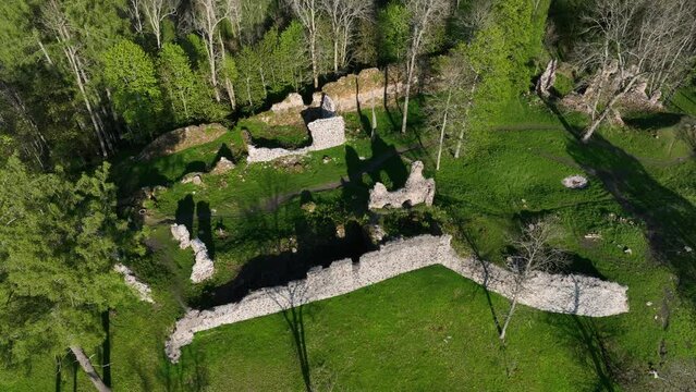 Aerial drone view of Helme Order Castle with strong shadows on a sunny evening, Estonia.
