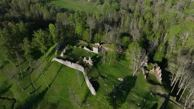 Approaching aerial view of Helme Order Castle on a sunny evening. Estonia.