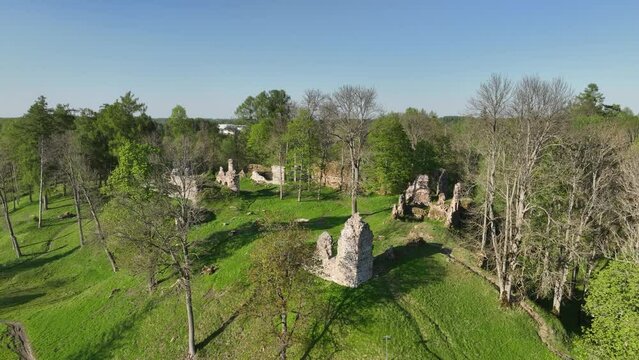 Slowly approaching aerial drone view of Helme Order Castle on a sunny evening. Estonia
