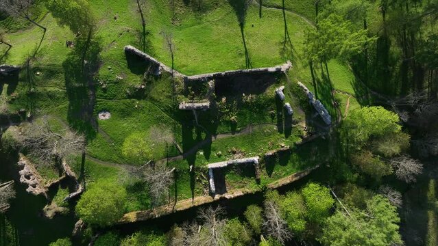 Top-down aerial of Helme Order Castle with strong shadows on a sunny evening, Estonia.