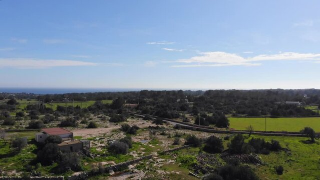 Drone ascending over fieds and trees on Formentera.