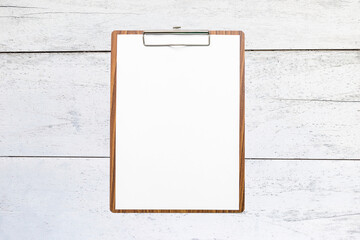 Blank wooden clipboard on old white wooden background, blank white paper on wooden clipboard