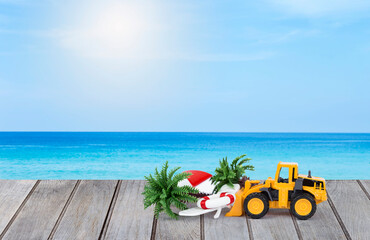 Miniature truck with coconut tree and beach chair over blurred beach background, it's summer time,...