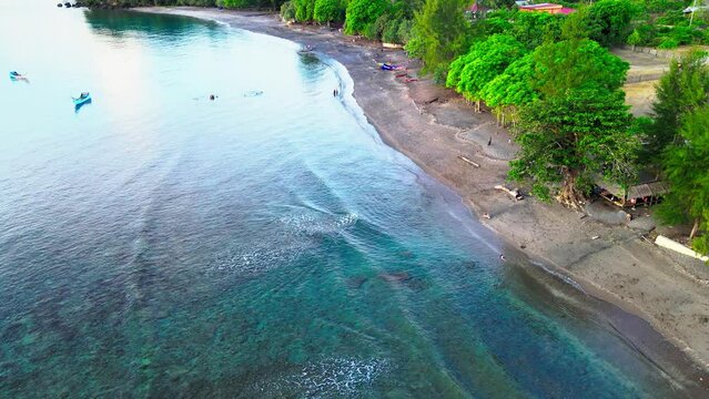 Human activity at the seaside and then focusing on the sea water swash