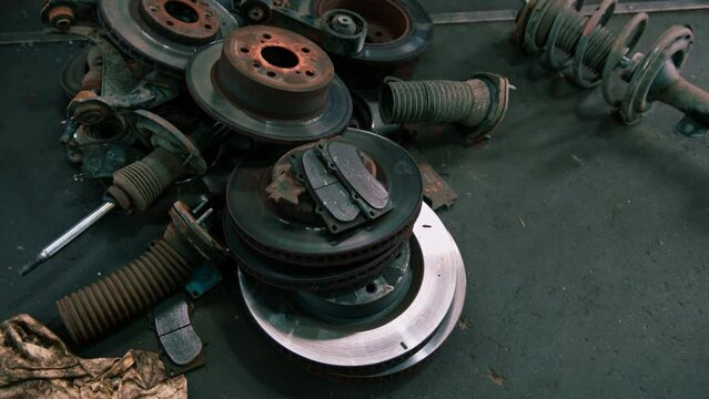 Close-up of old broken brake discs that lie at a car service car detailing admiration concept