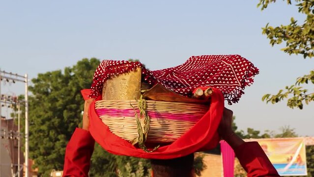people carrying holy offering at head on the occasion of chhath festival in india