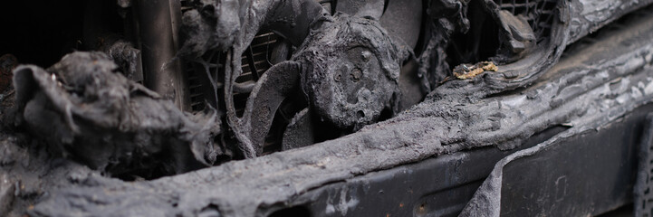 Burnt engine compartment of modern car. Burnt out car and faulty electrical wiring in car