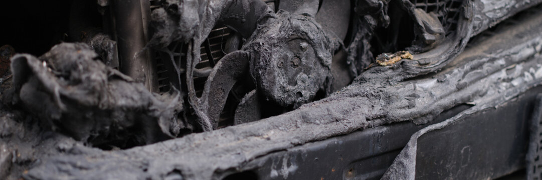 Burnt engine compartment of modern car. Burnt out car and faulty electrical wiring in car