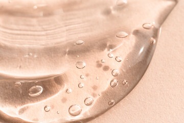 Macro texture of a gel, soap, hygiene product on a beige background. Skin cleanser sample.