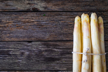 Bunch of white asparagus on wooden background

