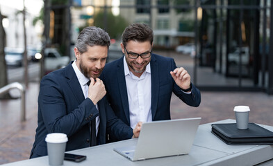 two successful businessmen trading online. businessmen trading online outdoor.