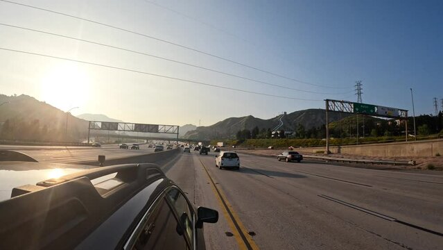 Driving northbound on Interstate 405 in the HOV lane - driver point of view at sunset