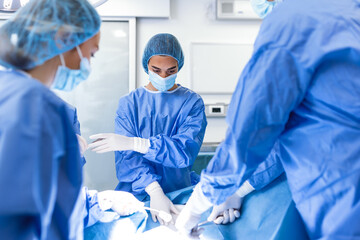 Surgery operation. Group of surgeons in operating room with surgery equipment. Medical background,...