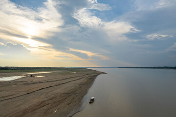 Aerial view of the Amazon river. Boat near the shore