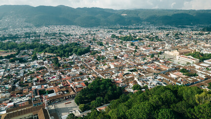 Fototapeta na wymiar Beautiful aerial view of the rooftops of the old colonial buildings in the city of san cristobal de las Casas on the sunset