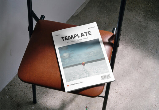 Mockup of closed A4 magazine with customizable front cover on chair