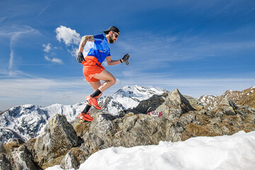 An athlete trains uphill running in the mountains