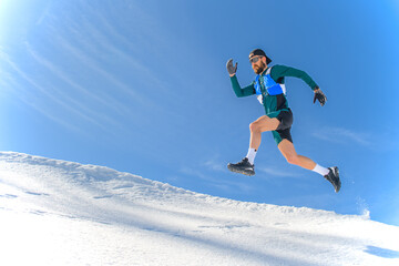 A sportsman jumps in the snow - 609830220