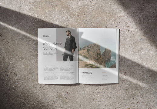 Mockup of open A4 magazine with customizable content against concrete