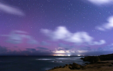 pink purple night sky over the ocean