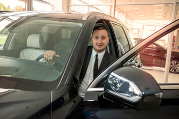 buyer client inside modern car at showroom, concept of sale or rent vechile