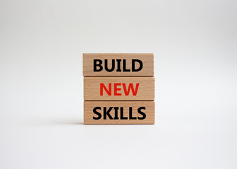 Build New skills symbol. Concept word Build New skills on wooden blocks. Beautiful white...