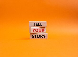 Tell your story symbol. Wooden blocks with words Tell your story. Beautiful orange background. Business and Tell your story concept. Copy space.