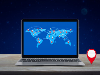 Map pin location button with connection line and world map on laptop computer screen on wooden table over fantasy night sky, Map pointer navigation online, Elements of this image furnished by NASA