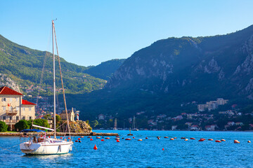 Fototapeta na wymiar Yacht moored at the Bay of Kotor . Bay of water in Montenegro 