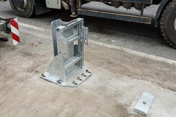 Installation of support in median crash barriers on highway. Bolts nuts screw washer in the...