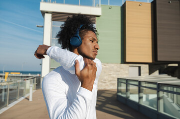 Athlete with bluetooth headphones exercising at pier