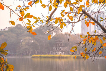 Hoan Kiem Lake ( Ho Guom) or Sword lake in the center of Hanoi in the fog in the morning. Hoan Kiem Lake is a famous tourist place in Hanoi. Travel and landscape concept. Selective focus.