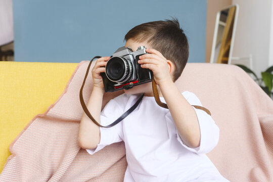Boy photographing with vintage camera