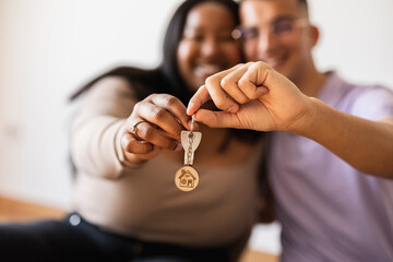 Couple holding house key in new home