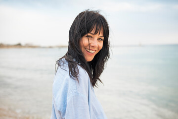 Cheerful woman spending vacations at beach
