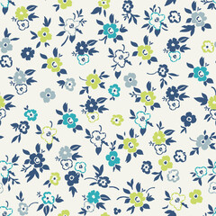 Cute floral pattern in a small flower. Seamless vector texture. An elegant template for fashionable prints. Print with small white and blue, green and light green flowers. Light background.