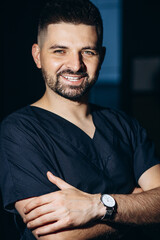 Male doctor, physician in blue lab coat isolated in studio