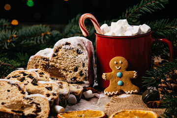 Christmas stollen on wooden background. Traditional christmas german dessert cut into pieces. Cake...