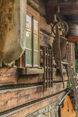 Old wooden agricultural tools hanging on the wall of the Stara Zagroda ethnographic museum in Ustroń in the Silesian Beskids (Poland) housed in a traditional highlander's cottage.