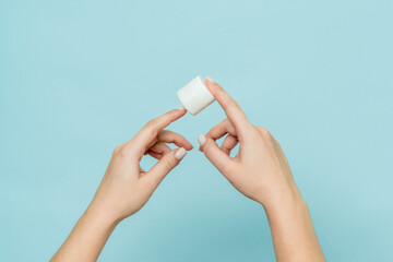 Woman's hands hold jar of cream or ointment. Packaging cosmetic product