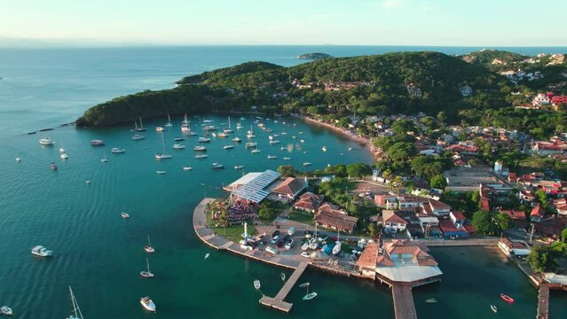 Praia dos Ossos in B&uacute;zios, Brazil, aerial drone view with rotating motion on a clear cloudless sky.