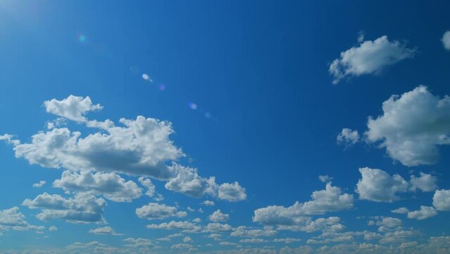 Blue sky white puffy fluffy clouds billow in high space. Sky with clouds weather. Time lapse.
