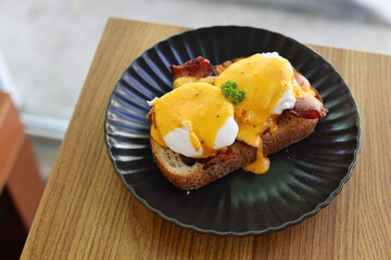 Fried egg on bread for breakfast on plate and rustic table