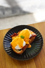 Fried egg on bread for breakfast on plate and rustic table
