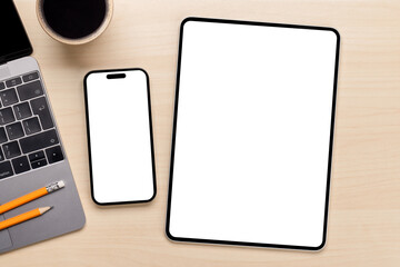 Blank screen smartphone and tablet on a desk