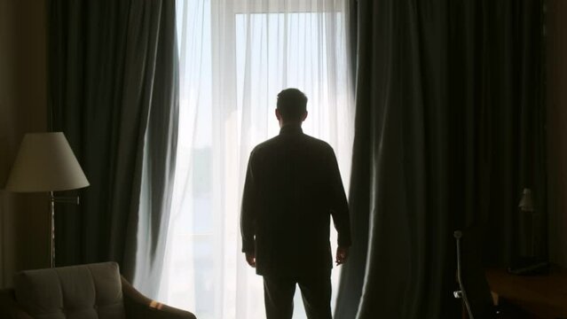 The young man puts on a white shirt. The groom puts on a suit on the street and fastens the buttons. Businessman buttoning his shirt sleeves. The young man is going to a meeting.