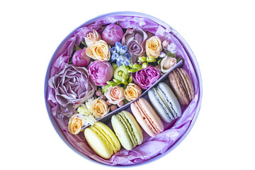 Round cardboard box with buds of small roses and colorful macaroons. View from above. Isolate. PNG

