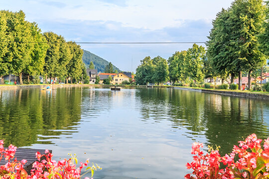 The pond in Ustroń in the Silesian Beskids (Poland) on a sunny summer day - a place of relaxation for residents and tourists with the possibility of kayaking, boating or paddle boating.