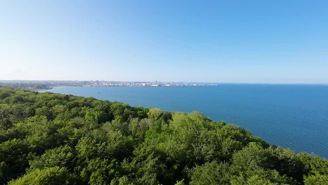 View of Aarhus from the Marselisborg forest over the water.